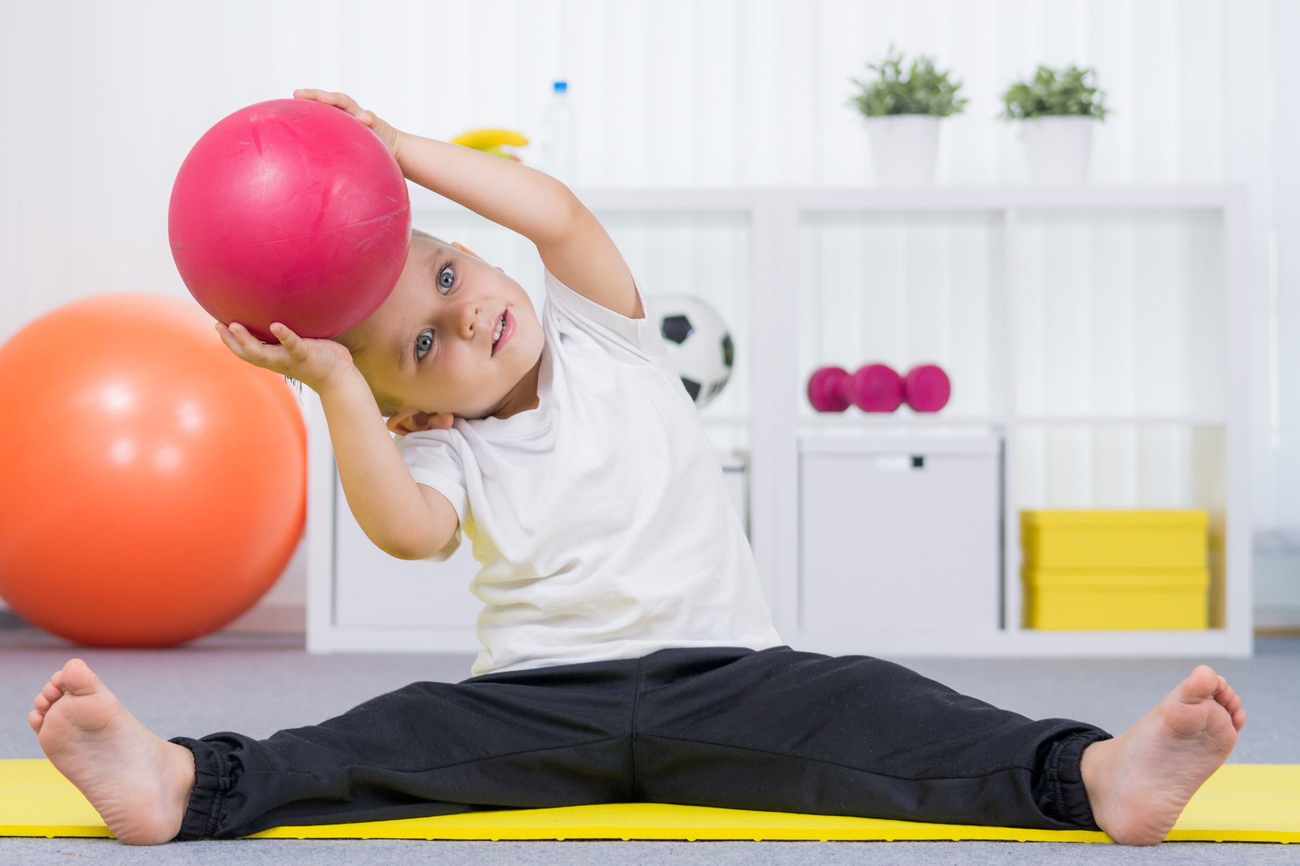 child with physical therapy ball