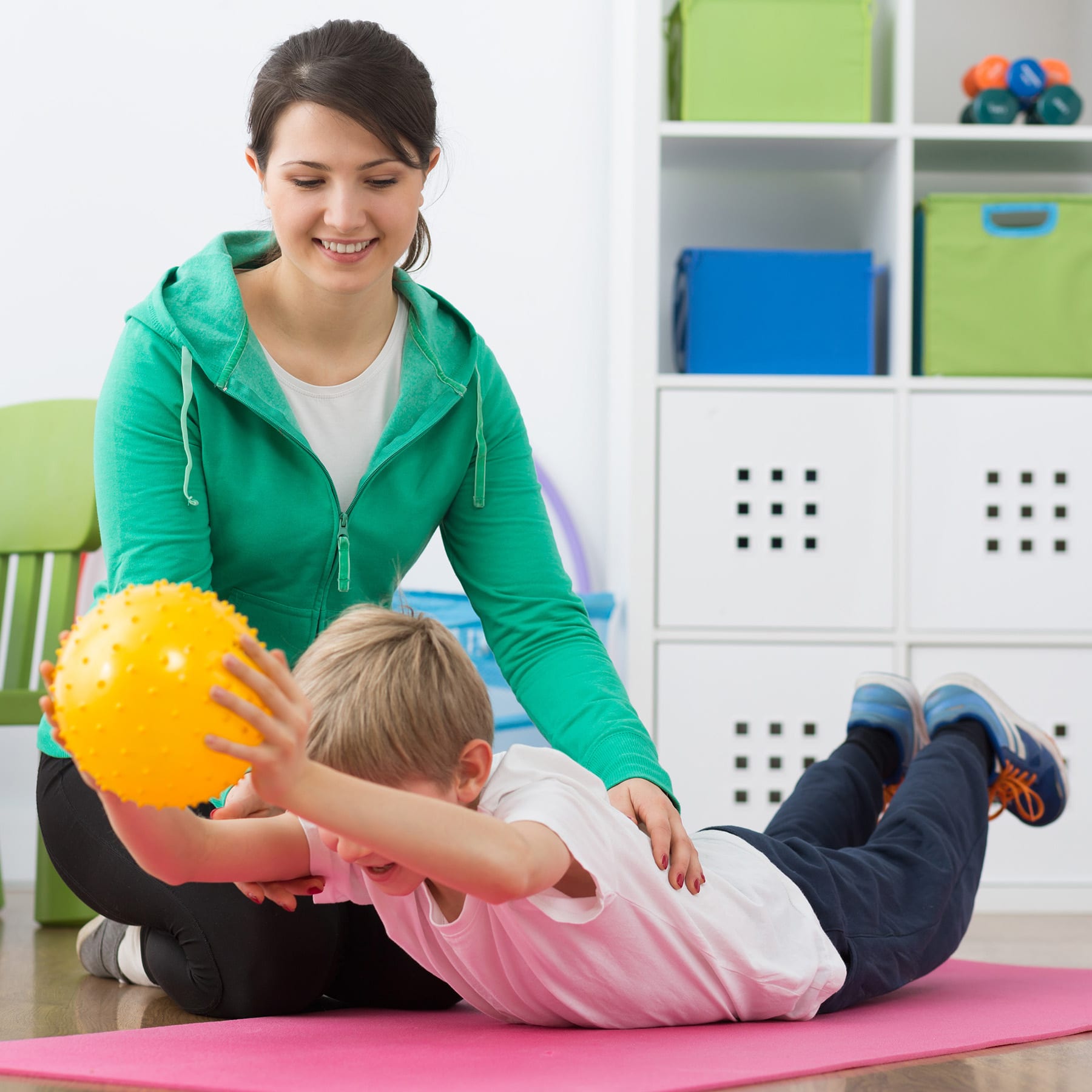 physical therapist helping child
